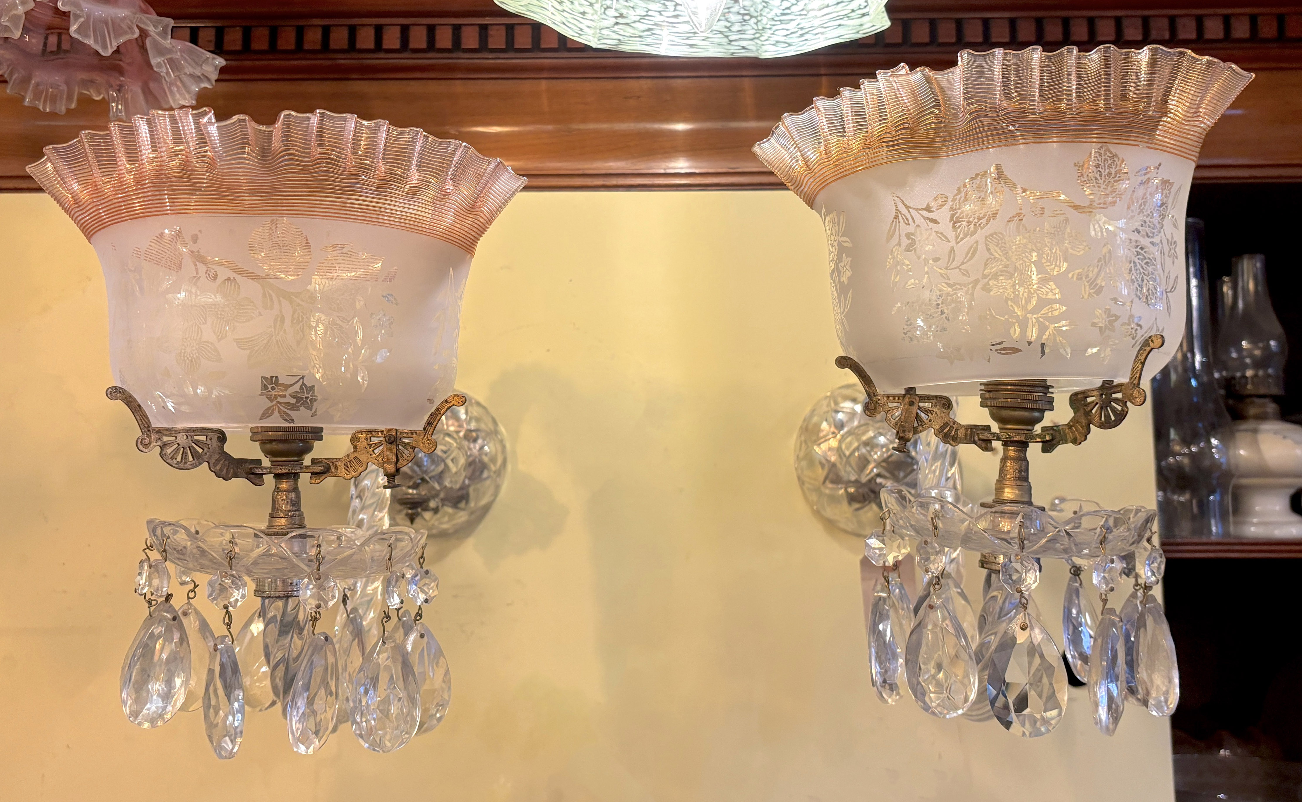 A pair of Victorian cut glass wall lights with etched frilled glass shades, height 32cm. depth 44cm